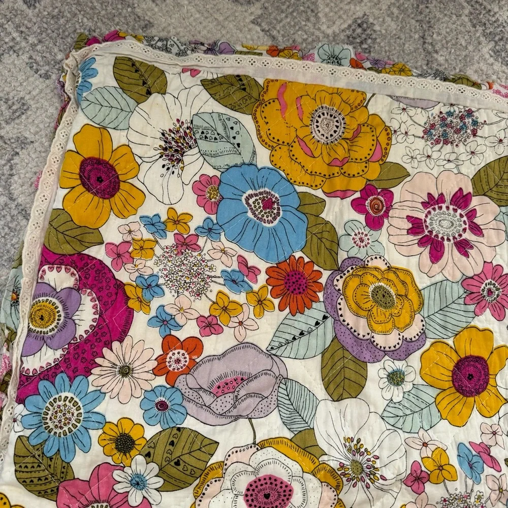 Cynthia Rowley quilted pillow sham with a multicolored boho floral pattern.
